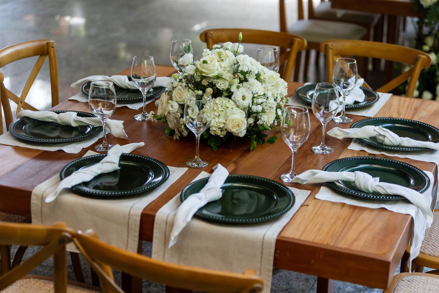 Table set with green china, linen napkins and white flowers